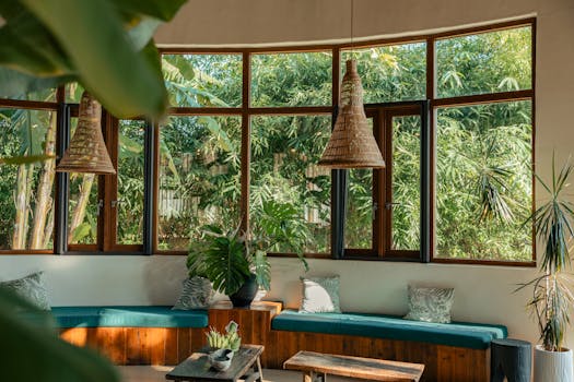 Inviting indoor seating area with large windows revealing lush greenery outside.