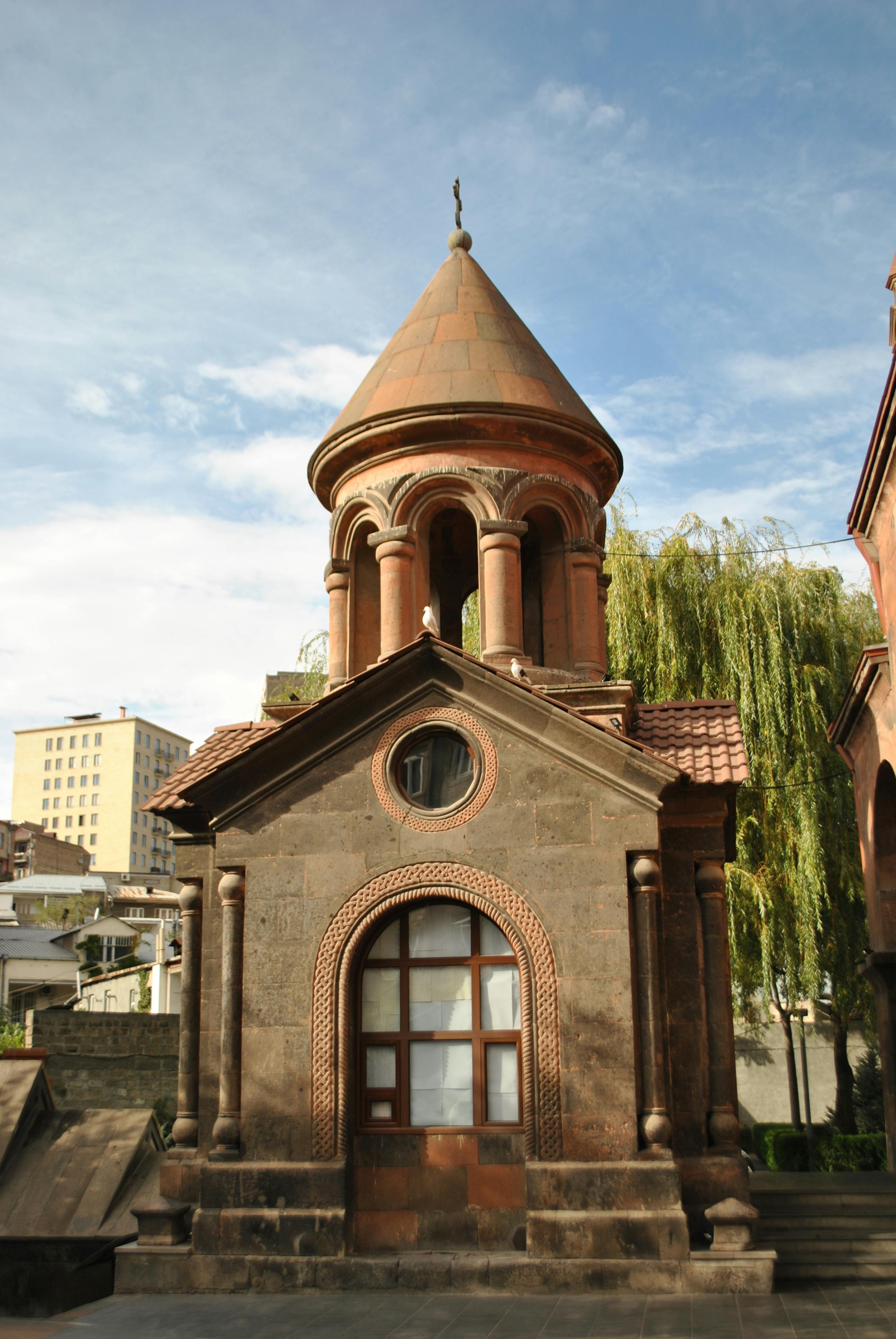 Explore stunning Armenian architecture under a clear blue sky, showcasing cultural heritage.