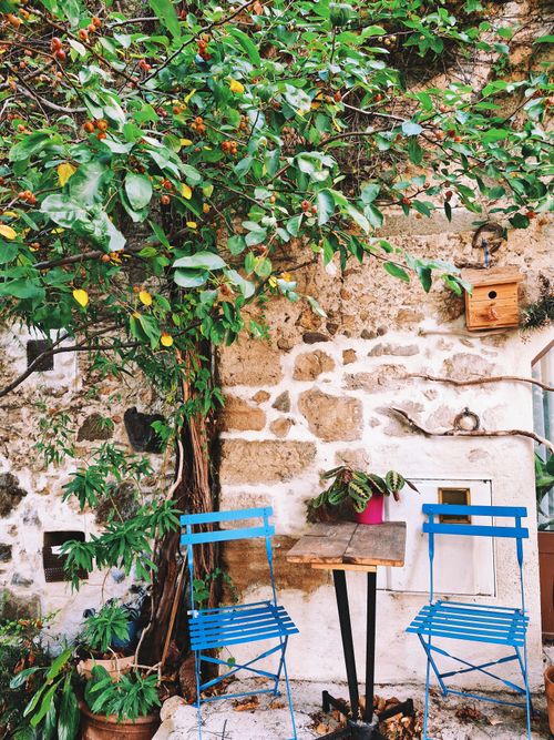 Free Relaxing outdoor cafe setting with blue chairs in Biot, Provence. Stock Photo