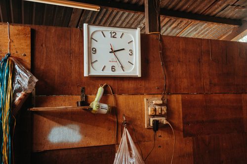 Free A wall clock hanging on a wooden wall in a rustic indoor setting, Kon Tum, Vietnam. Stock Photo
