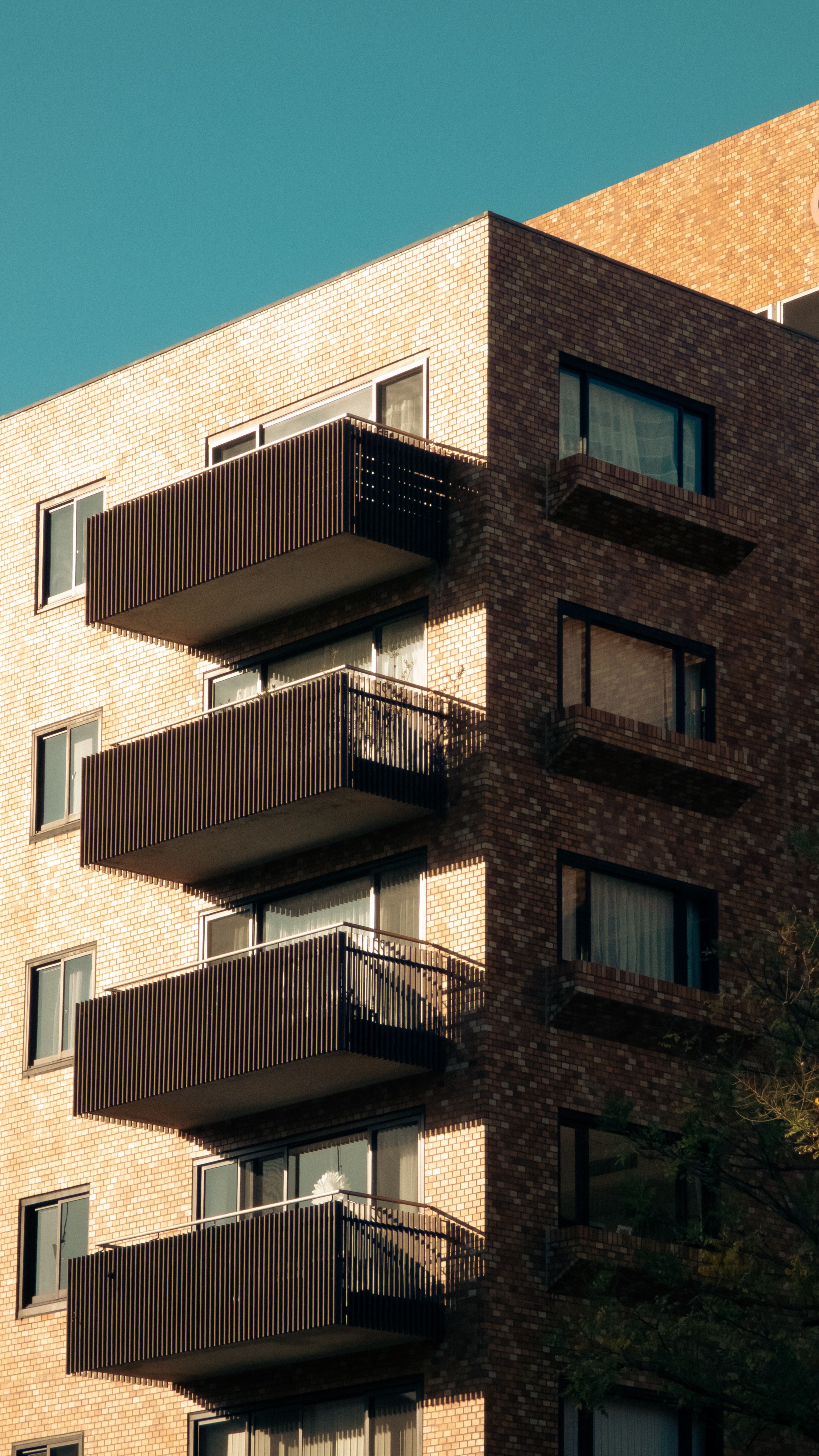Modern Brick Apartment Building with Balconies · Free Stock Photo