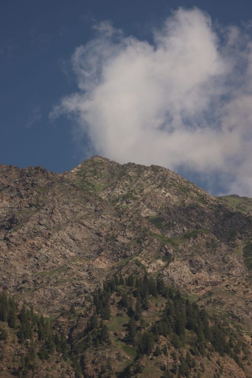 Free A stunning mountain range with rocky peaks under a cloudy sky during daytime. Stock Photo