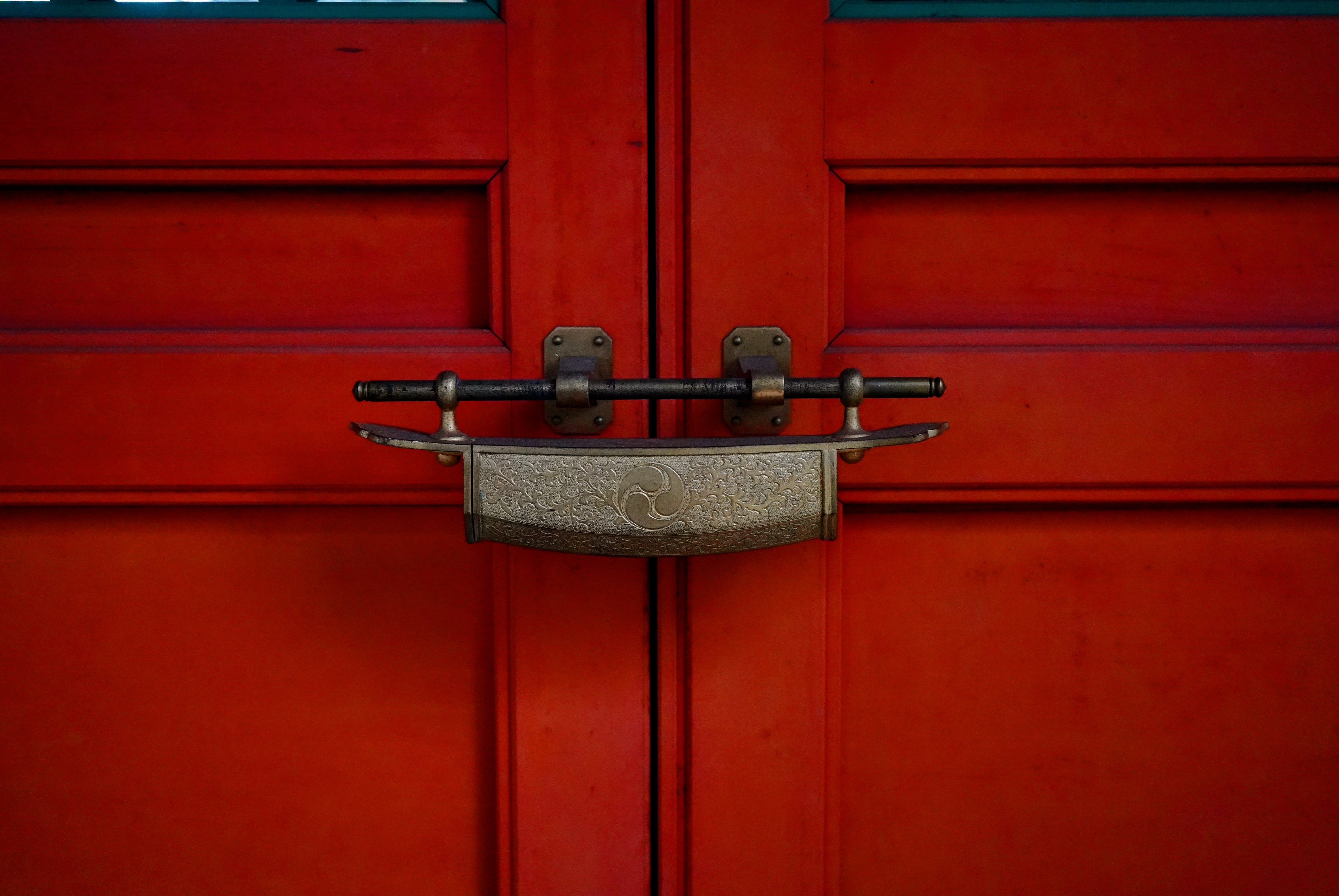 Decorative latch on a traditional wooden door.