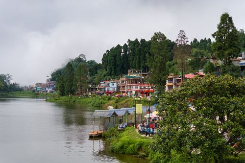 Free Picturesque view of Mirik Lake surrounded by lush greenery and misty mountains in West Bengal, India. Stock Photo
