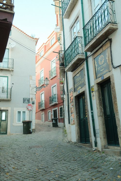 Free A picturesque, cobblestone alley in Lisbon's historic Alfama district on a sunny day. Stock Photo