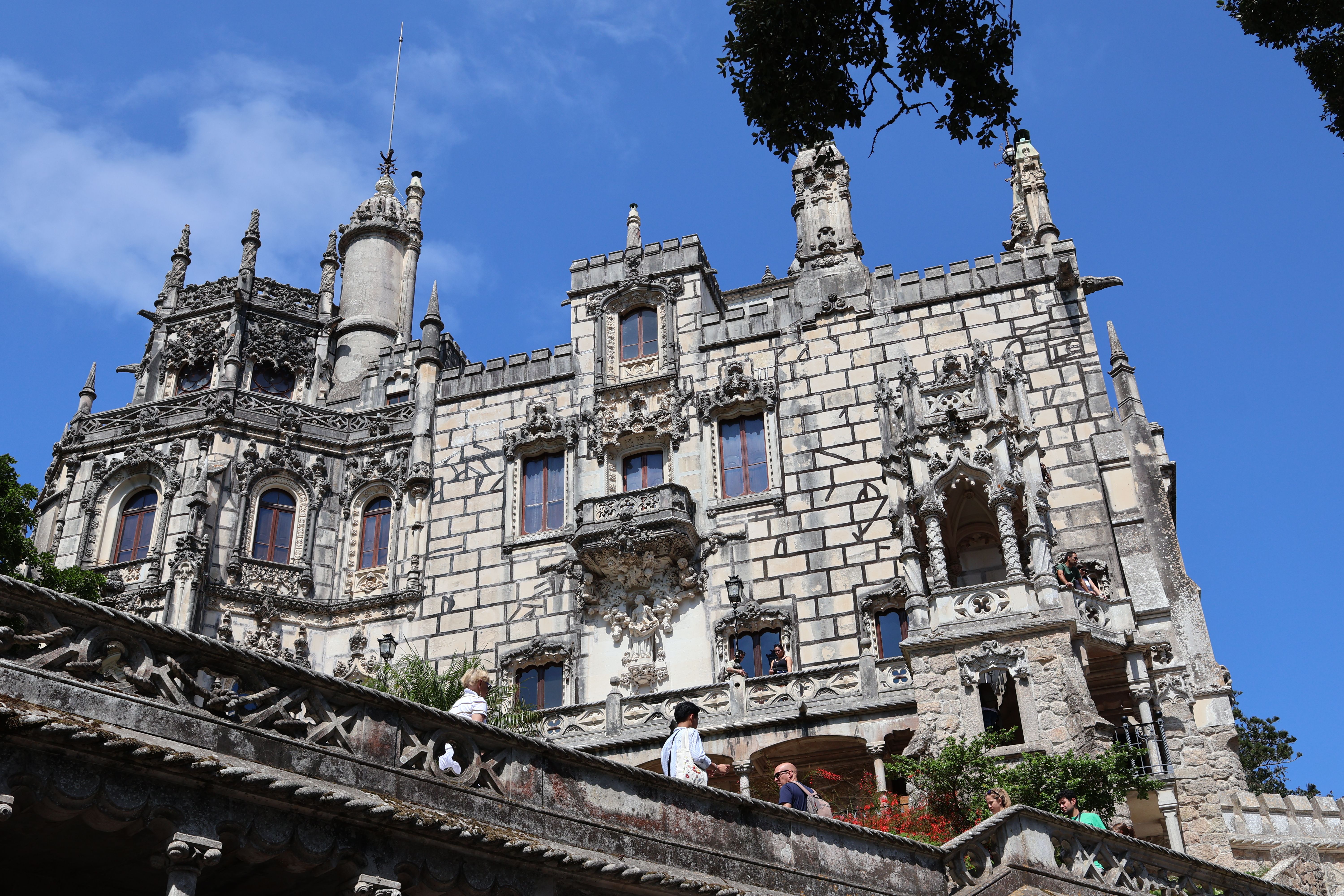 The spiral Initiation Well descending through moss-covered stone at Quinta da Regaleira