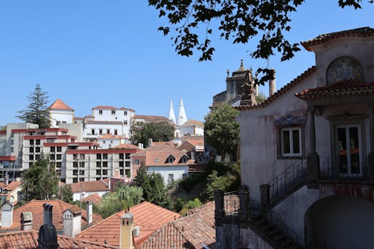 Beautiful view of Sintra's traditional architecture with a clear blue sky backdrop, showcasing historic charm and tiled rooftops.