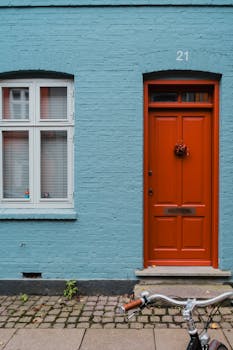 Colorful Copenhagen street view with vibrant door, window, and bicycle.