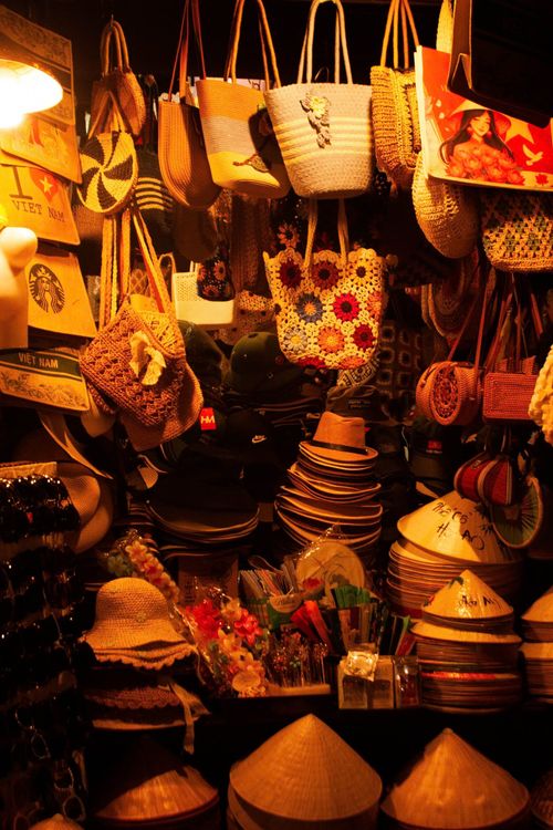 Free Colorful display of hats and bags at a Vietnamese market stall. Stock Photo