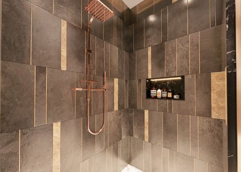 Luxurious modern shower with dark textured tiles and copper fixtures for a sophisticated bathroom design.