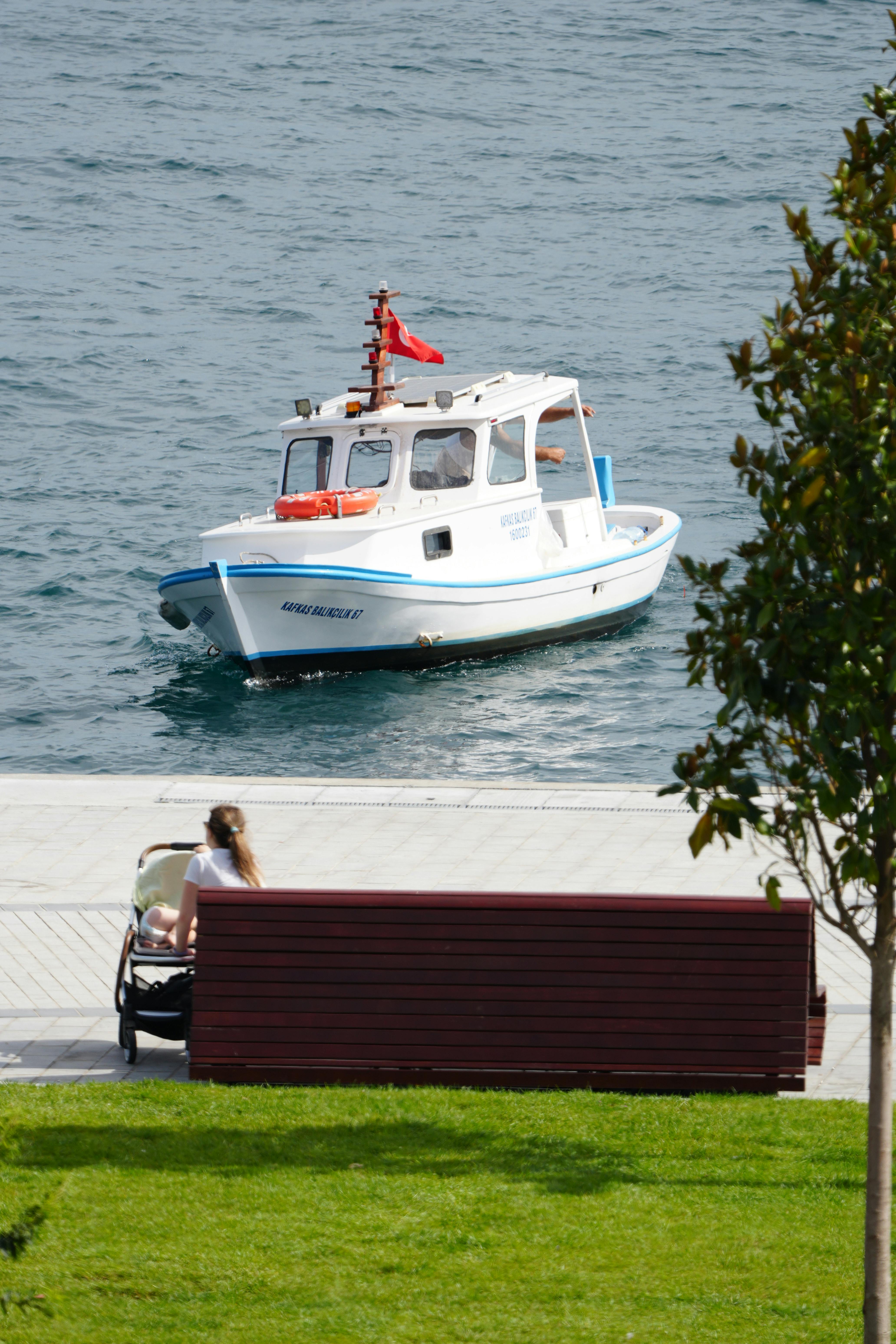 A peaceful scene of a boat on Bosporus with a mother and child in İstanbul.