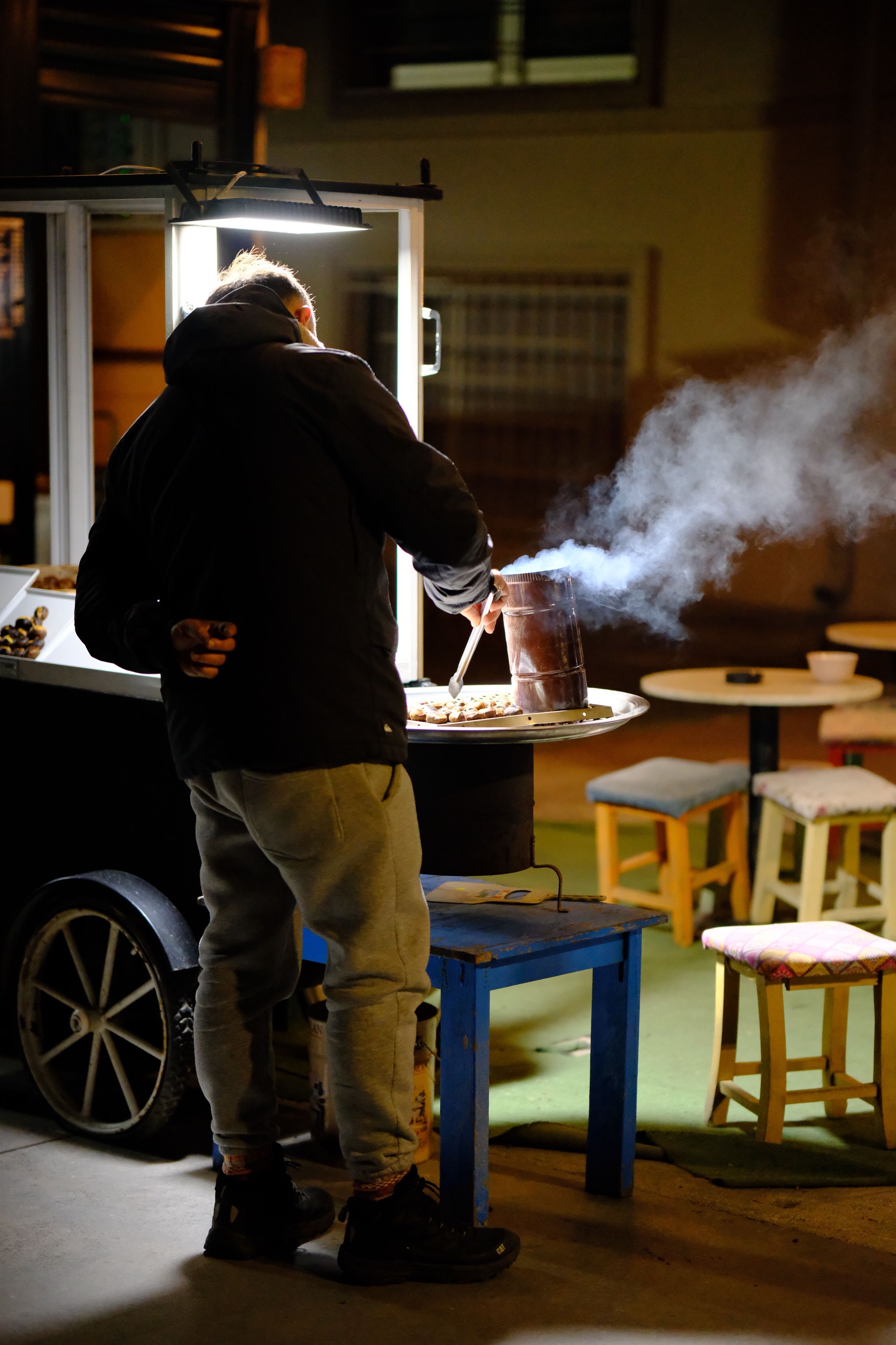 Street Vendor Roasting Chestnuts at Night · Free Stock Photo