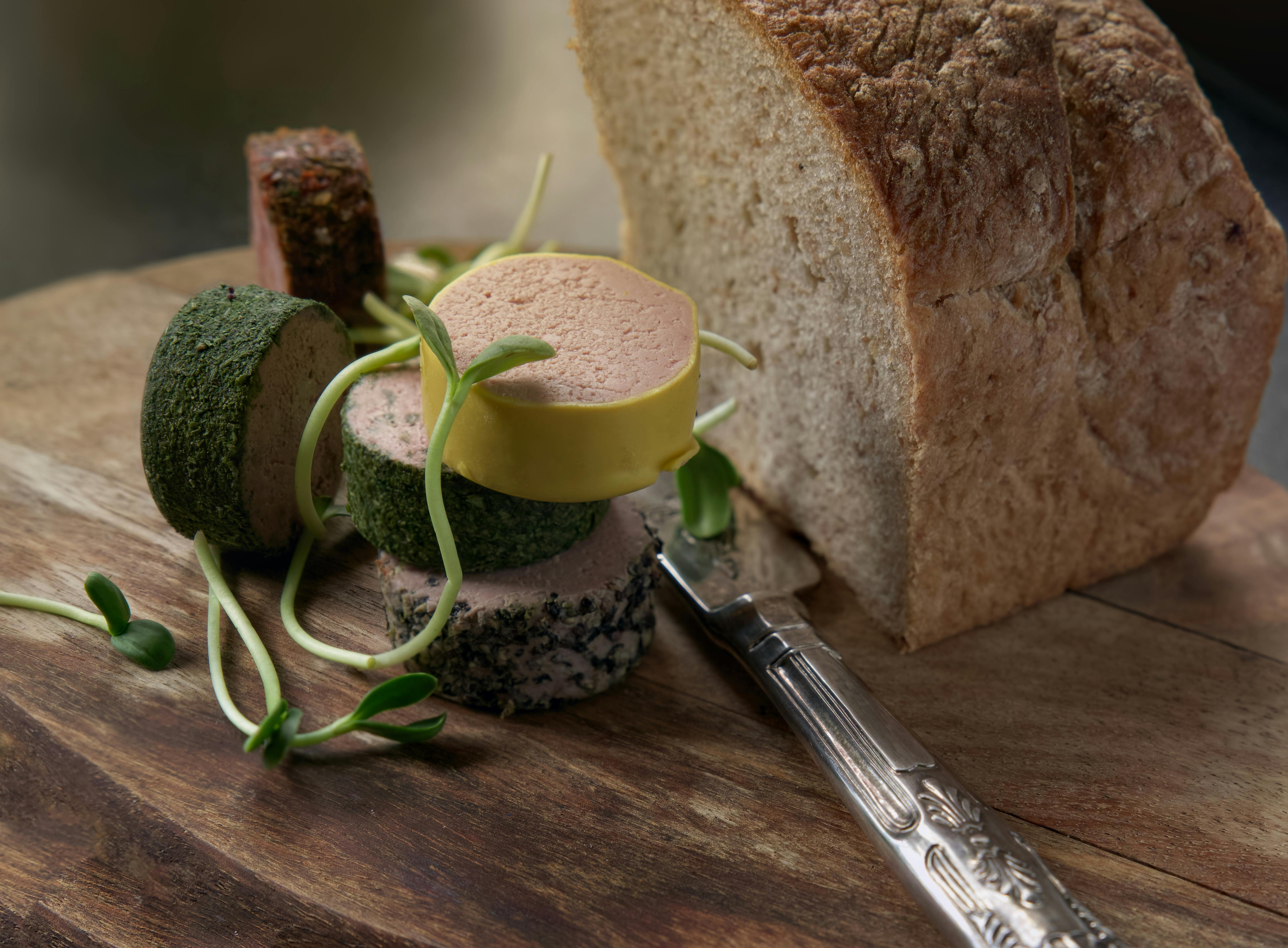Rustic bread and gourmet cheese selection elegantly displayed on a wooden board, ready for serving.