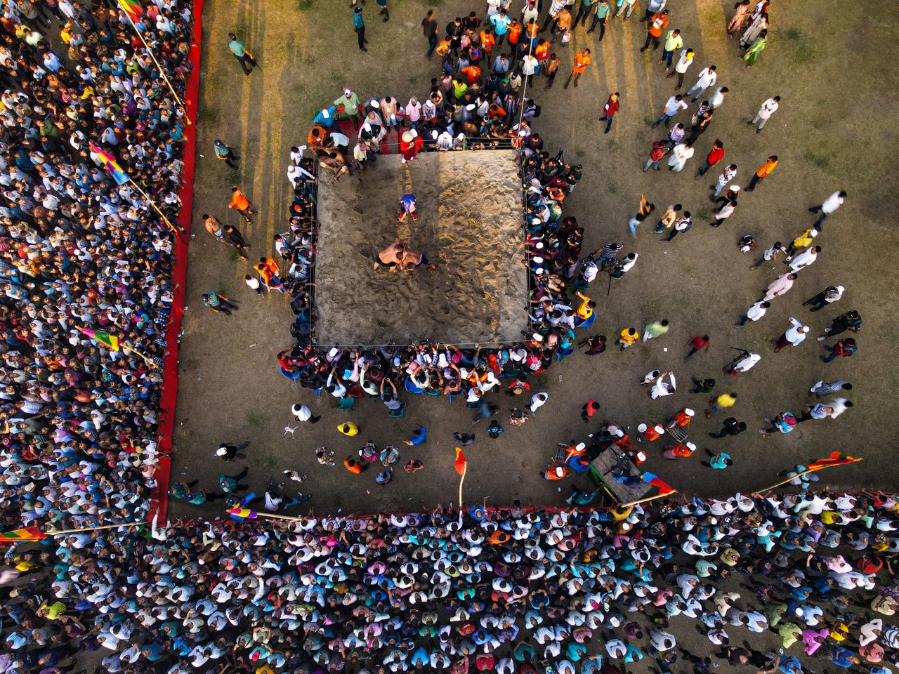 aerial shot capturing a vibrant wrestling match with a crowd in chatto