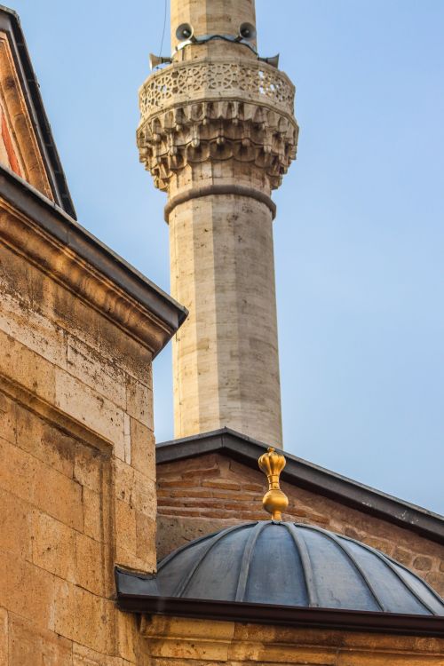 Free Close-up of a historic mosque's minaret and dome with intricate details in daylight. Stock Photo