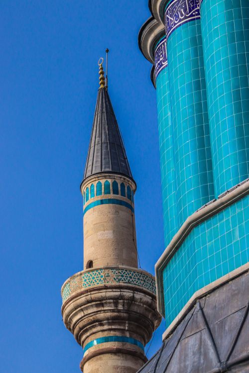 Free A striking image of a mosque's minaret and blue tiles set against a clear blue sky. Stock Photo