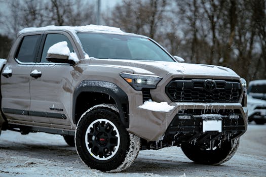 Robust off-road truck parked on a snowy ground during winter.