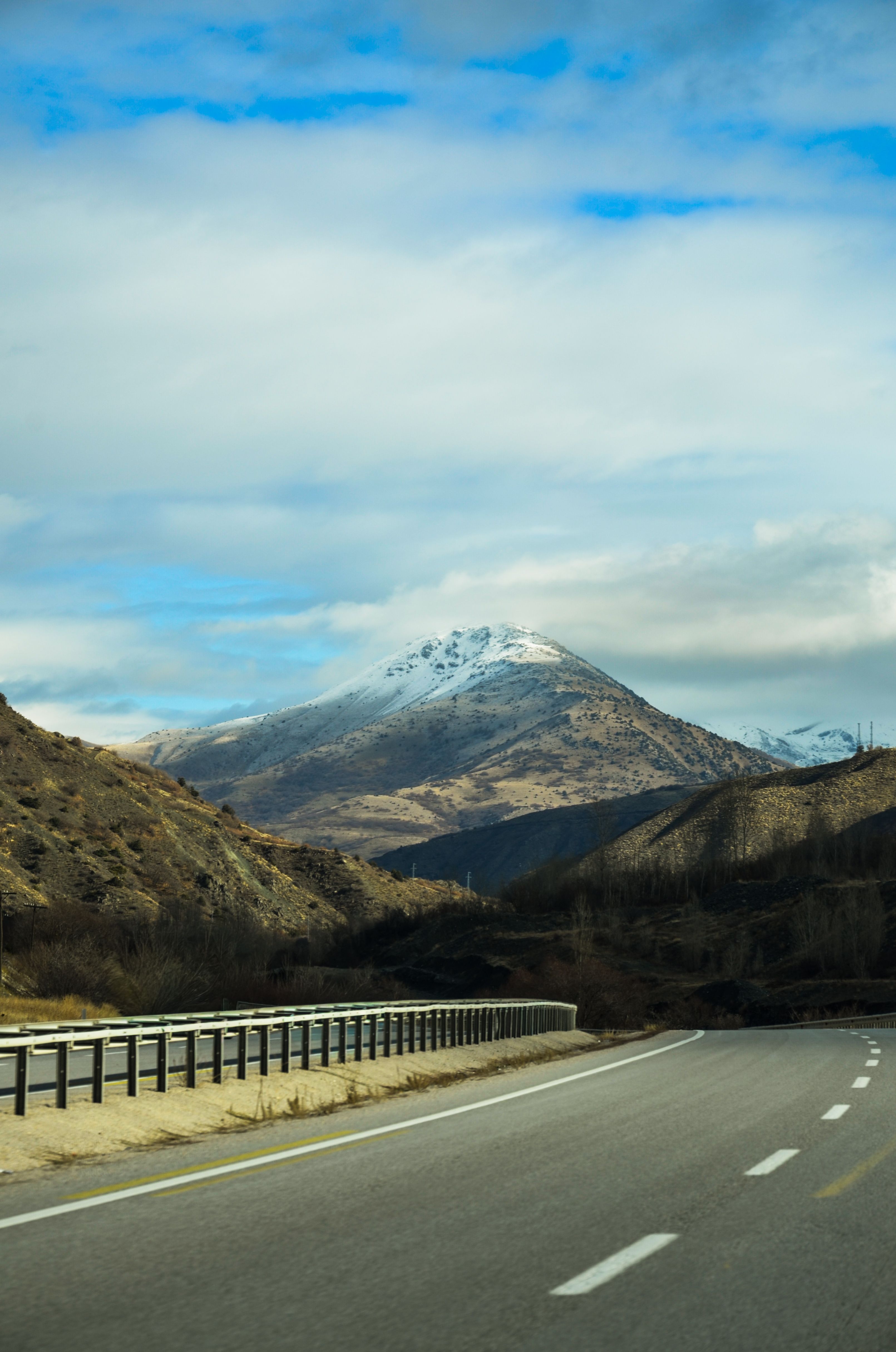 Scenic Mountain Road with Snow-Capped Peaks · Free Stock Photo