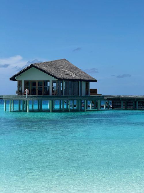 Free Stunning overwater bungalow on turquoise waters, perfect for tropical getaways. Stock Photo