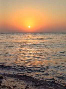 Captivating sunrise at Dahab beach, Egypt, with vivid colors reflecting on the Red Sea.