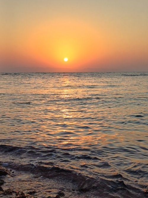 Free Captivating sunrise at Dahab beach, Egypt, with vivid colors reflecting on the Red Sea. Stock Photo