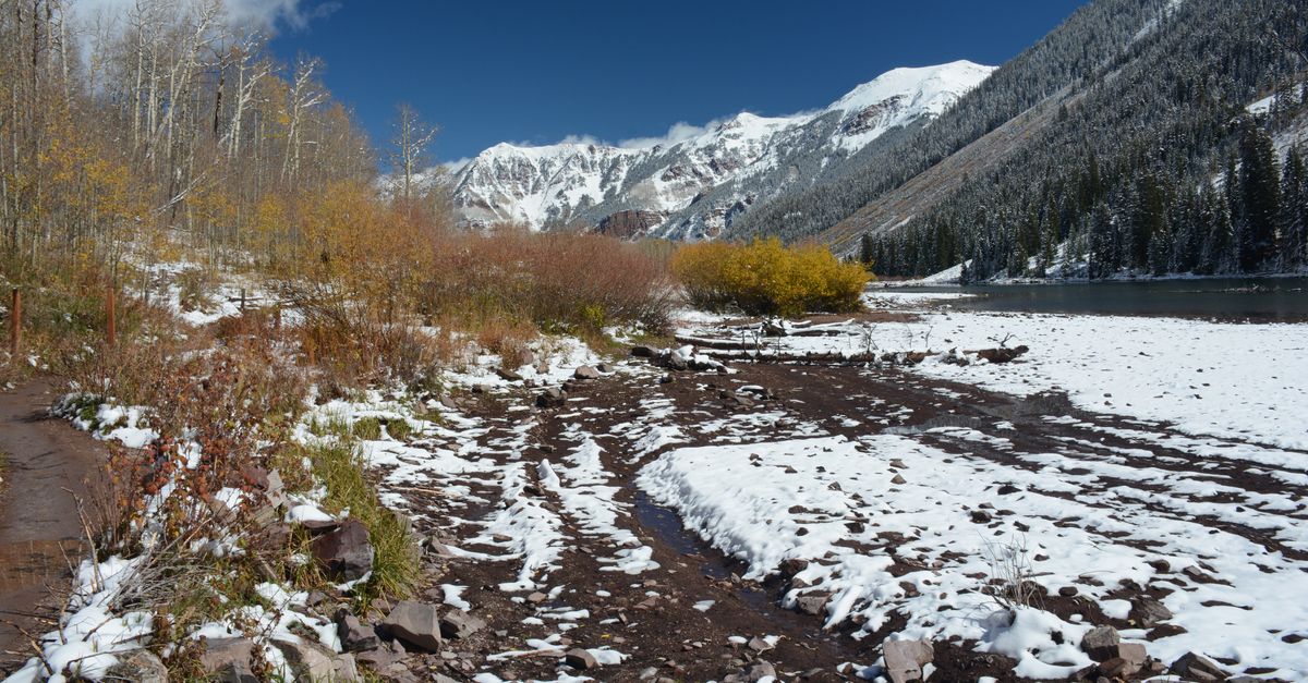 Beautiful snowy landscape with mountains and autumn foliage in Aspen, Colorado.