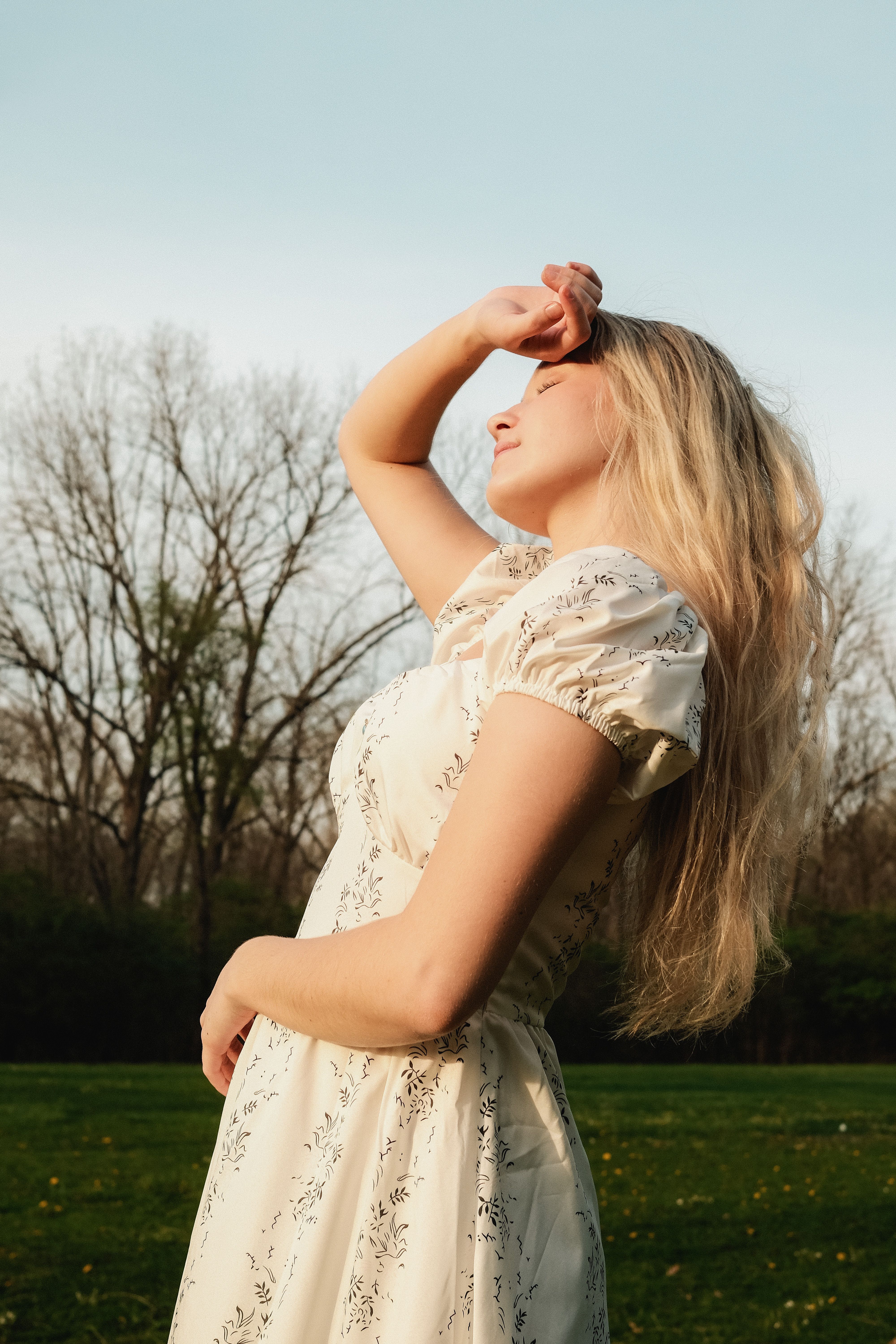 Woman Enjoying Springtime Sunshine Outdoors · Free Stock Photo