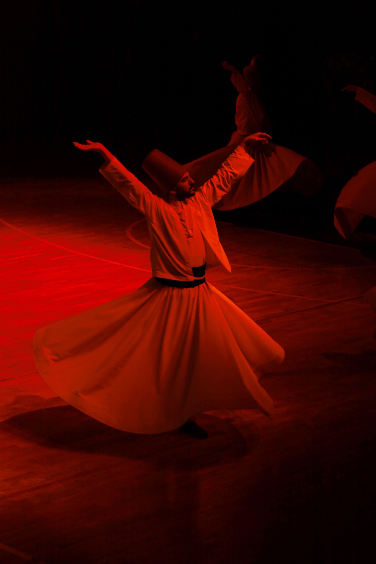 Dynamic whirling dervish performance in motion · Free Stock Photo