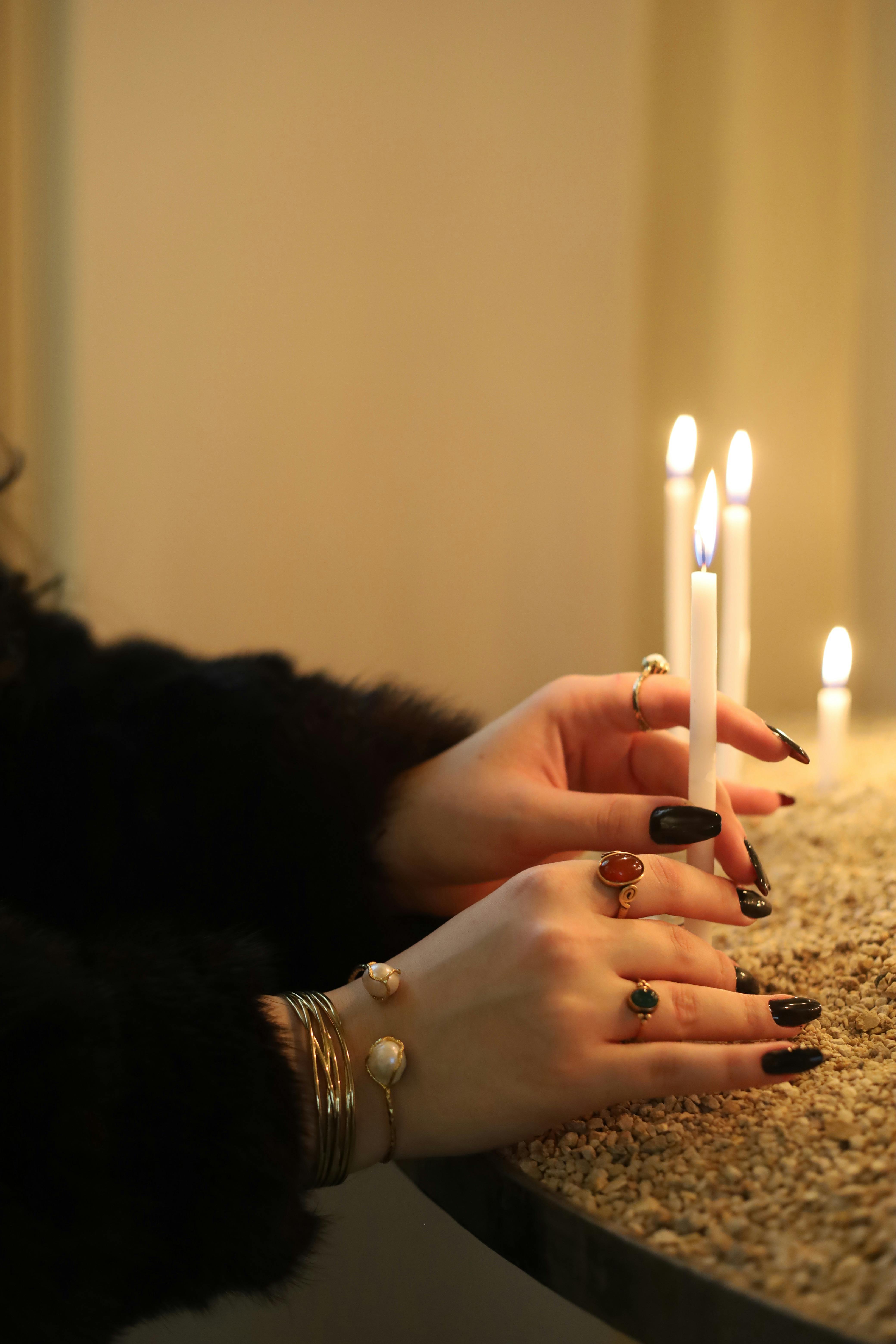 Elegant hands in soft candlelight ambiance, evoking sensual touch and intimate warmth