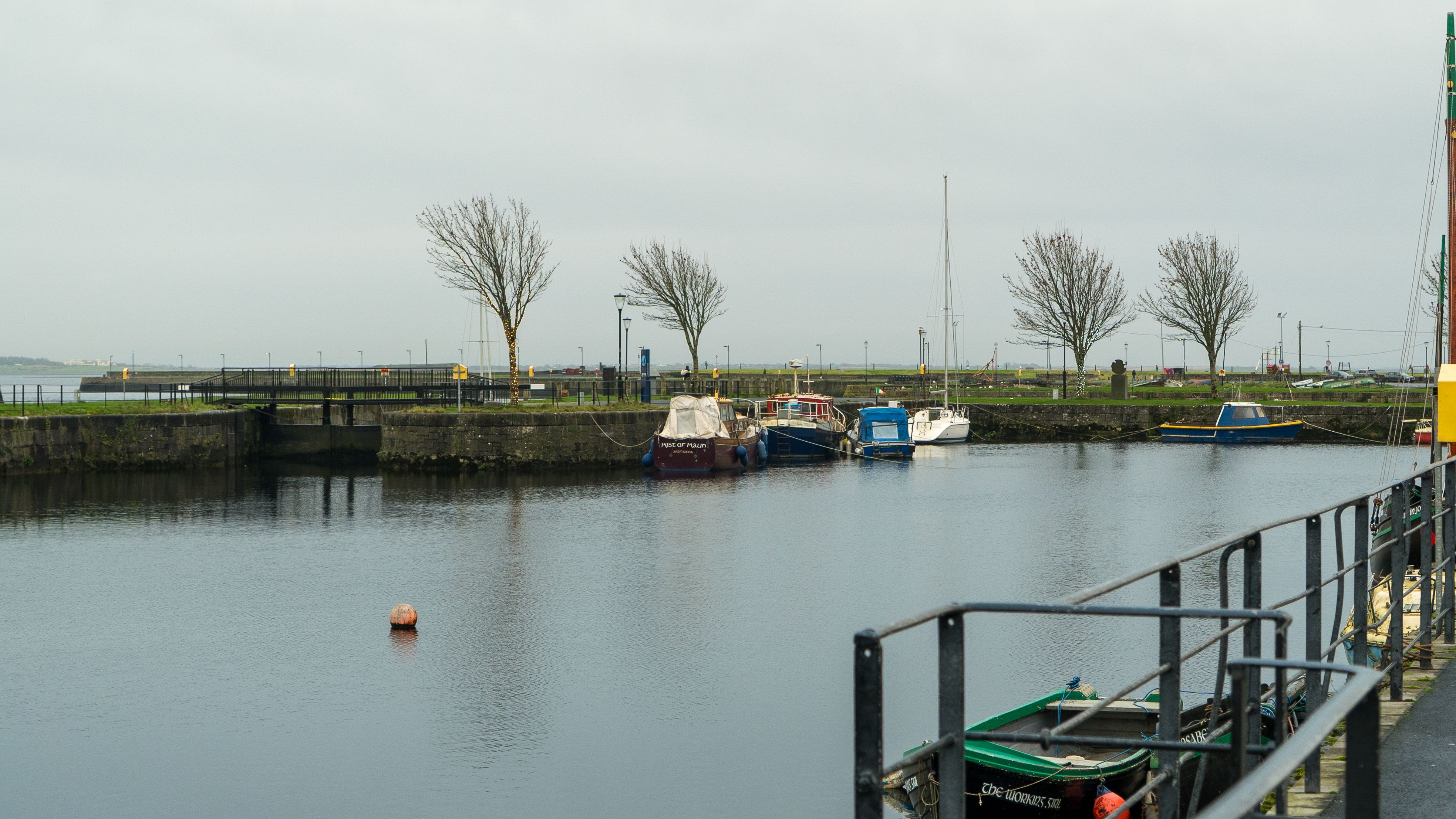 A river boat moored at a dock under overcast skies