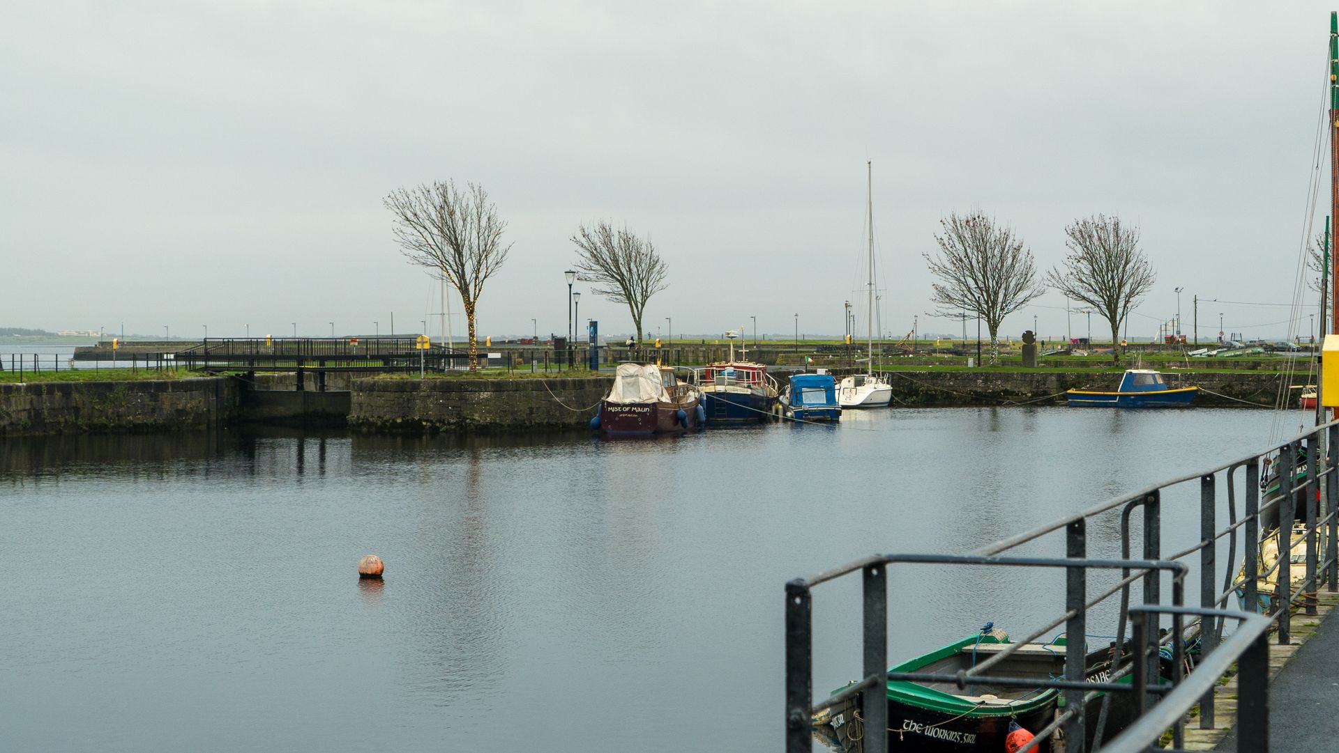 A river boat moored at a dock under overcast skies