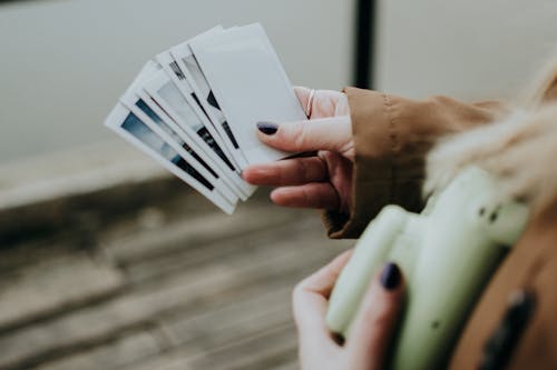 Person Holding a Polaroid Photos