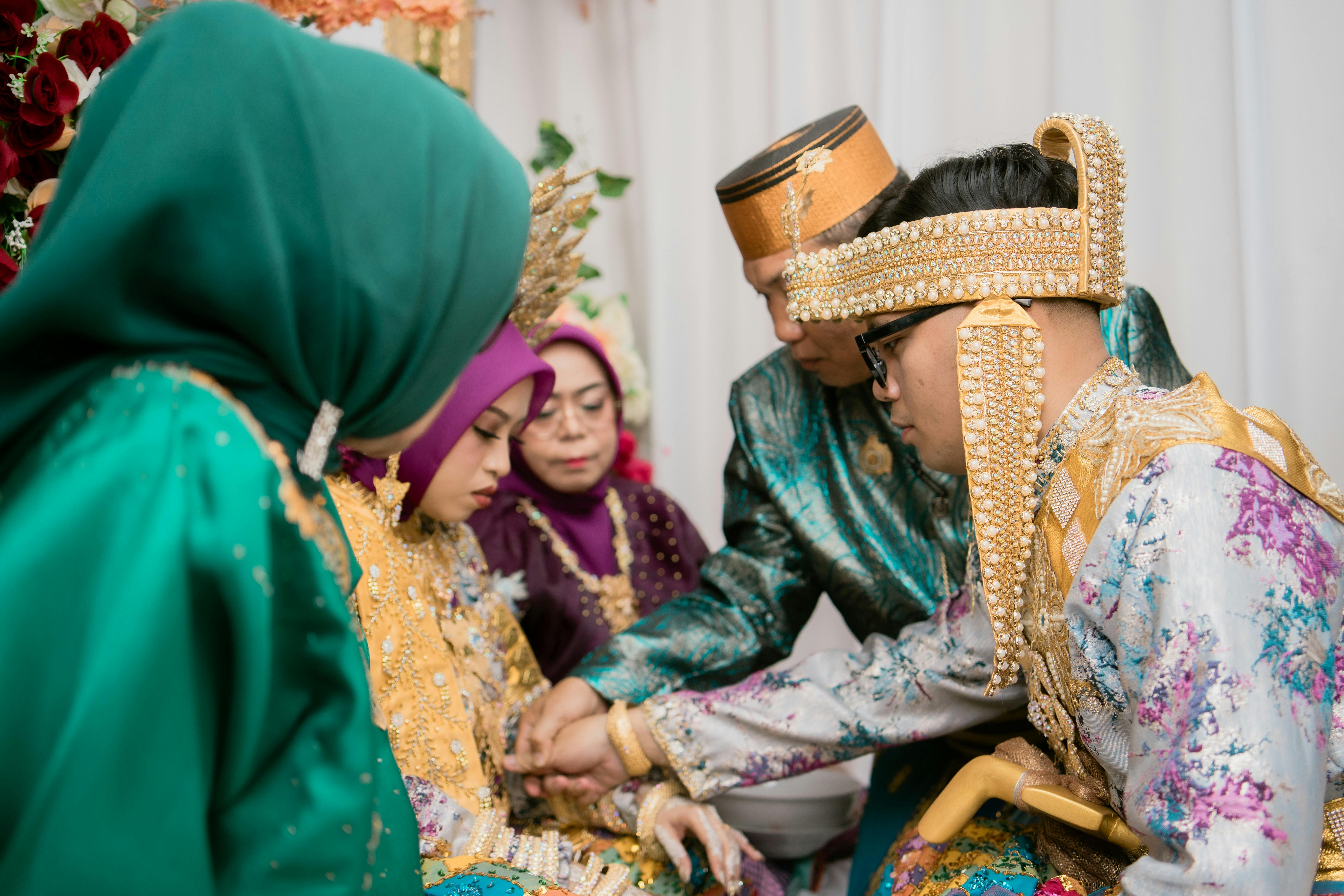 A beautiful moment during a traditional Indonesian wedding ceremony in Kendari, showcasing vibrant attire and cultural rituals.