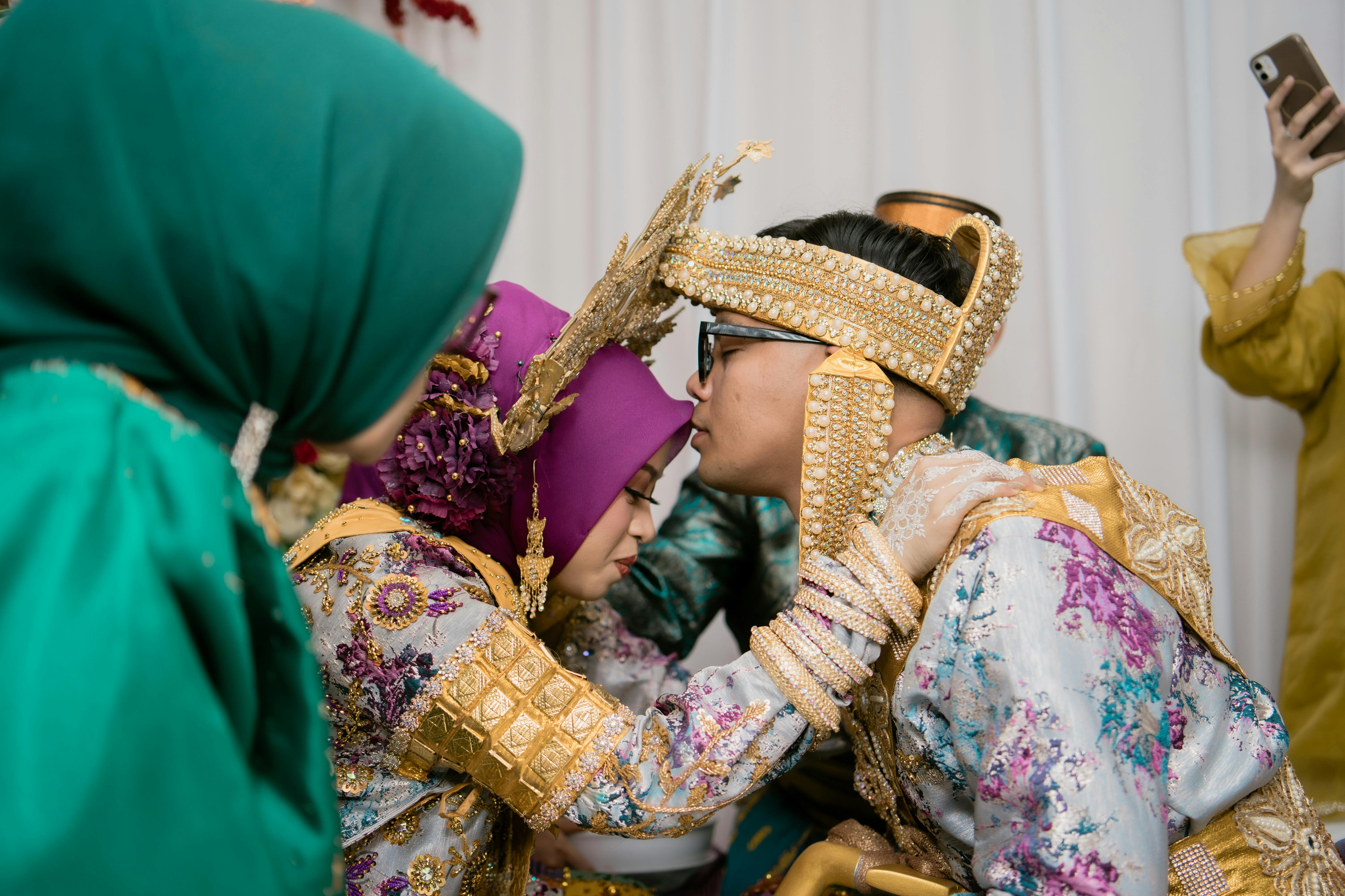 Capturing a tender moment during a traditional wedding ceremony in Kendari, Indonesia.