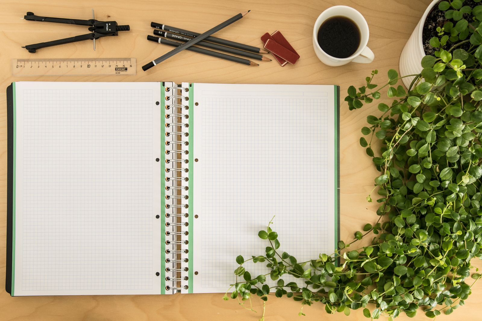 Open specification notebook on a desk with pencils, ruler and coffee ready for a detailed supplier RFQ