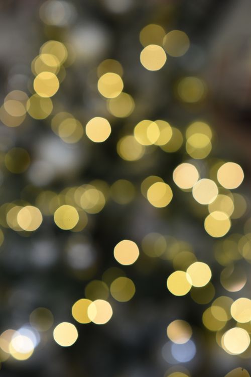 Free Abstract golden bokeh lights create a magical festive atmosphere, perfect for holiday backgrounds. Stock Photo