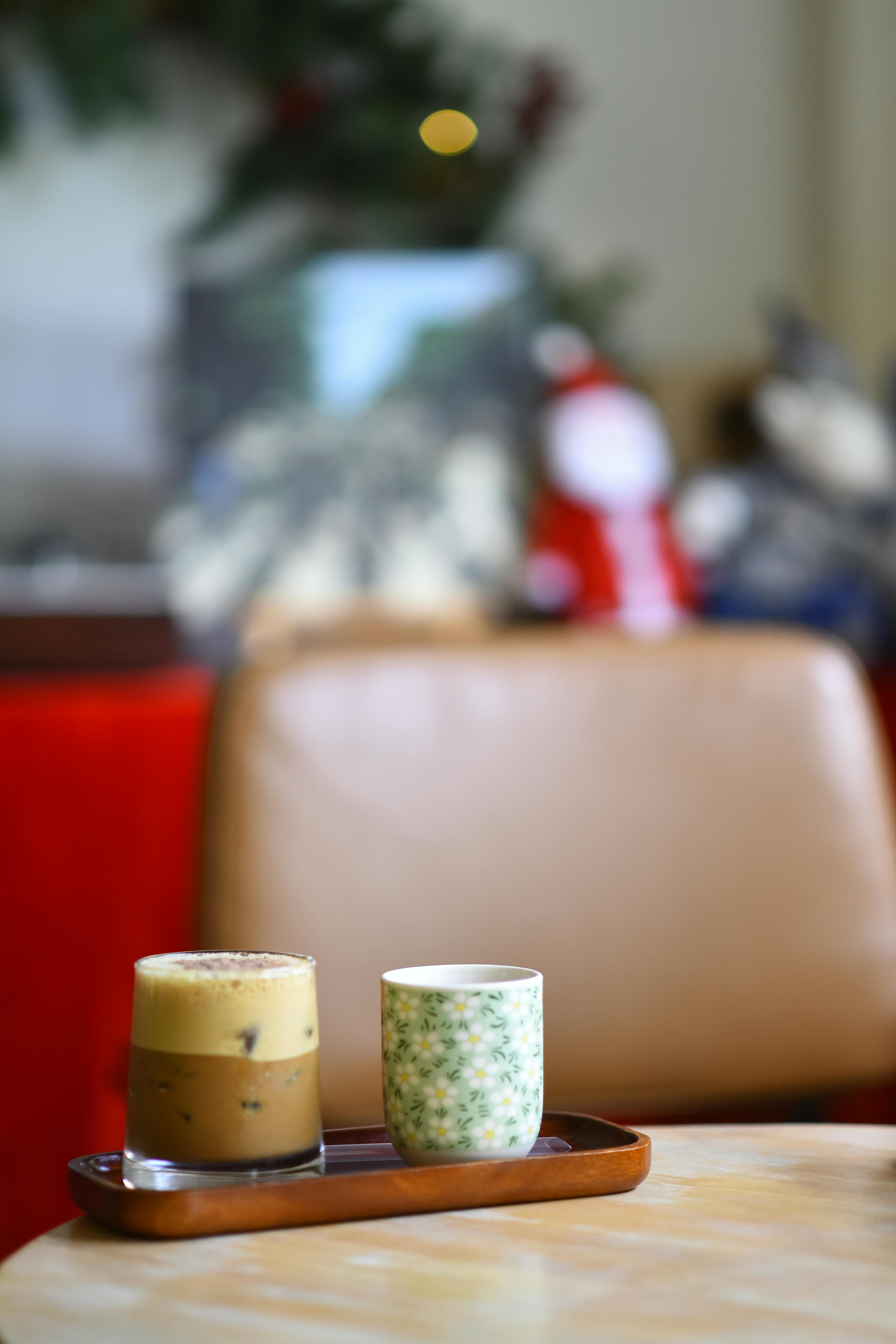 Charming indoor cafe with coffee and tea on a wooden tray, perfect for a cozy afternoon.