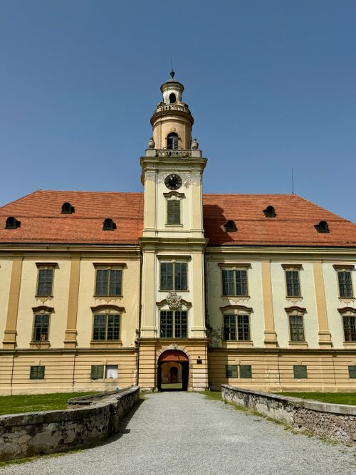 Free Historic Valpovo Castle showcasing architectural beauty under a clear blue sky. Stock Photo