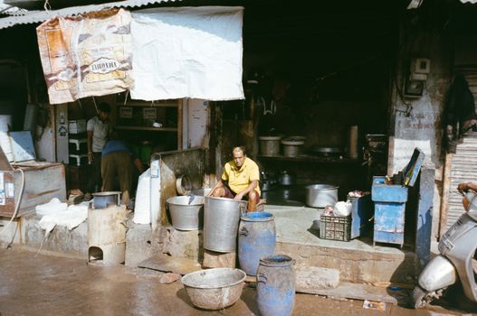 A street vendor prepares food in an outdoor market in Jaipur, Rajasthan, showcasing daily life in India.