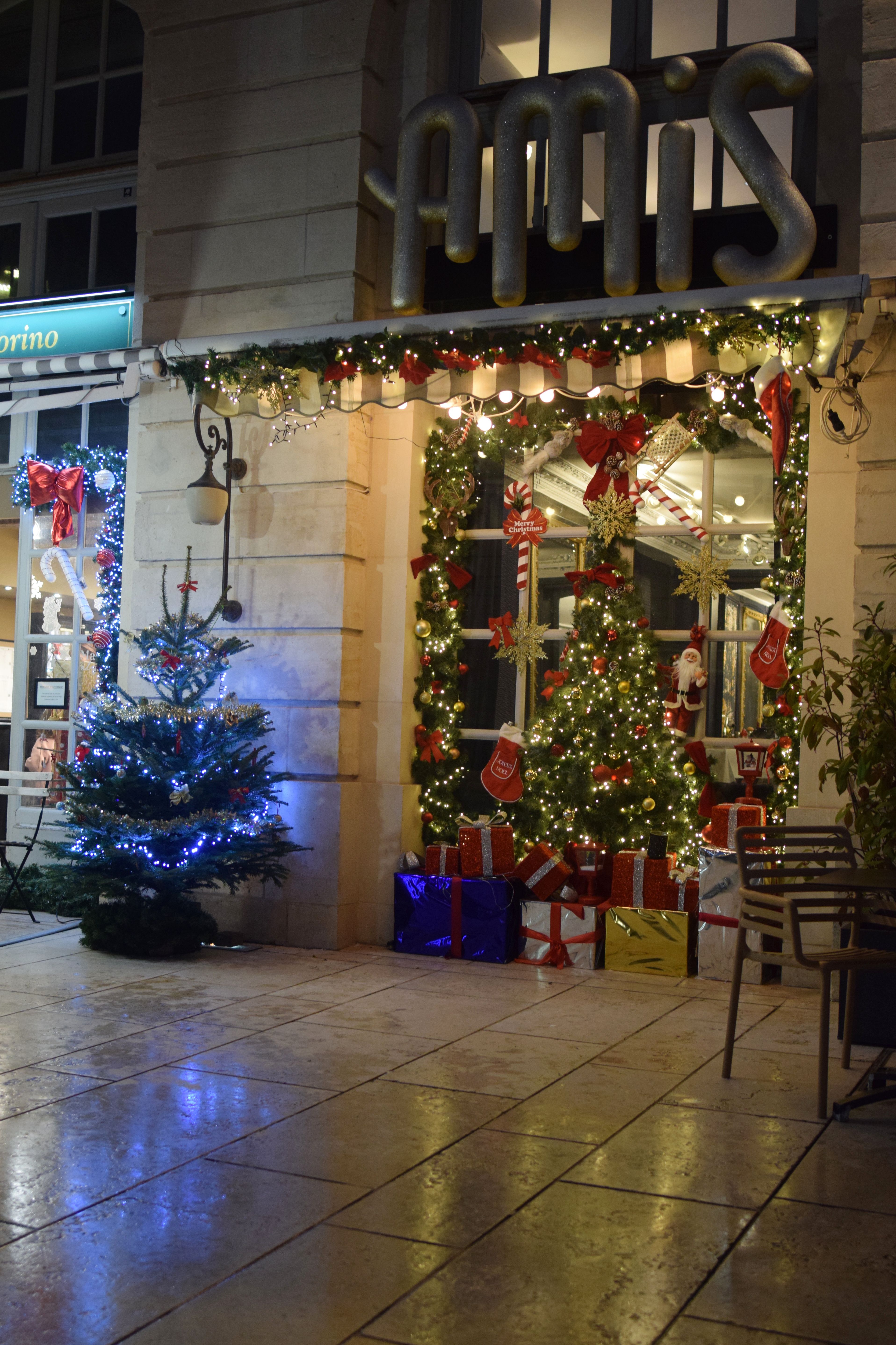 Beautifully decorated French shop with Christmas trees and gifts.