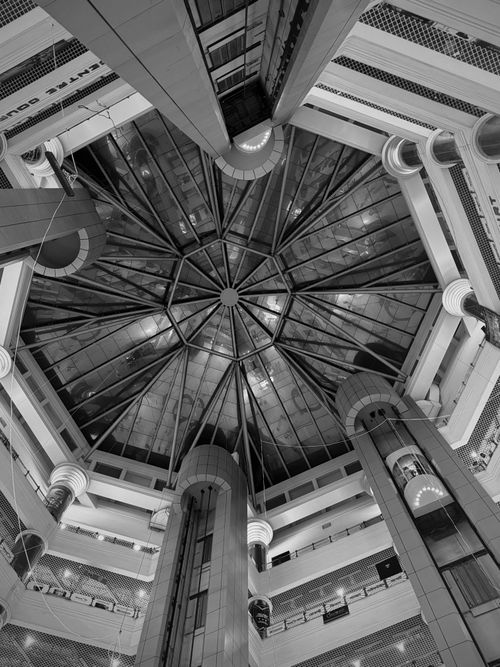 Free Black and white view of a geometric glass ceiling in a modern architectural setting. Stock Photo