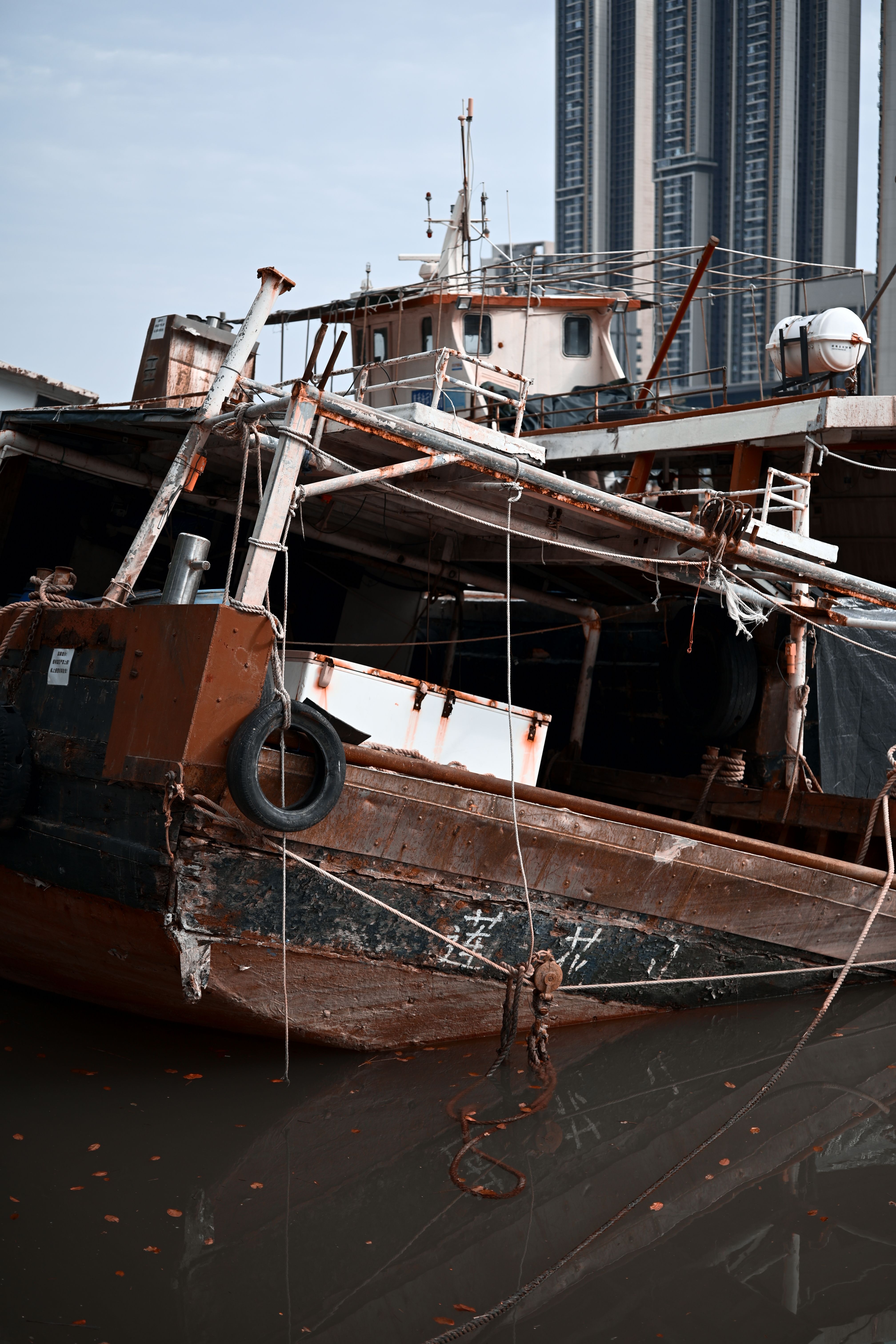 Old Rusted Fishing Boat on Murky Waterfront · Free Stock Photo
