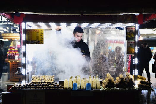 Street vendor at night selling roasted corn and chestnuts in İstanbul, Türkiye.