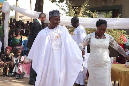 A vibrant outdoor African wedding ceremony with joyful bride and groom.