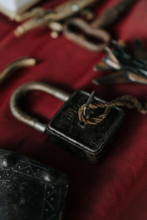 Free Close-up of a vintage lock with keys on a red cloth surface, evoking a rustic charm. Stock Photo