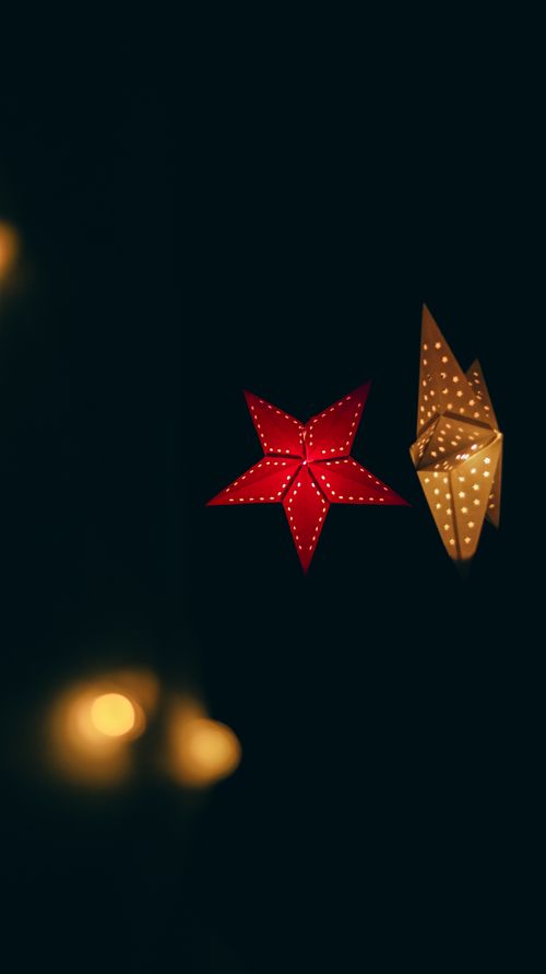 Free Bright festive star and light decorations creating a warm holiday atmosphere. Stock Photo