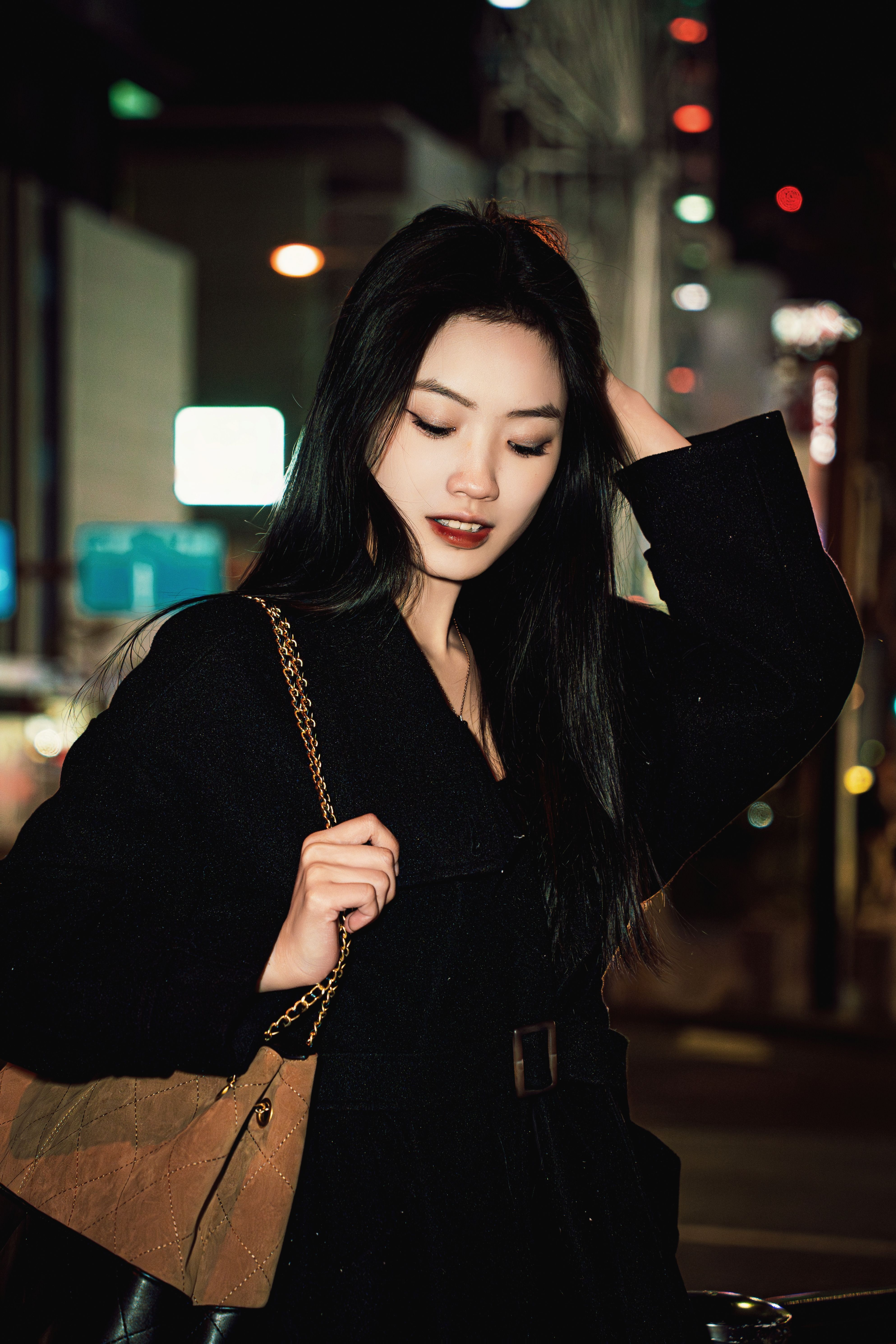 Elegant woman at night in urban setting