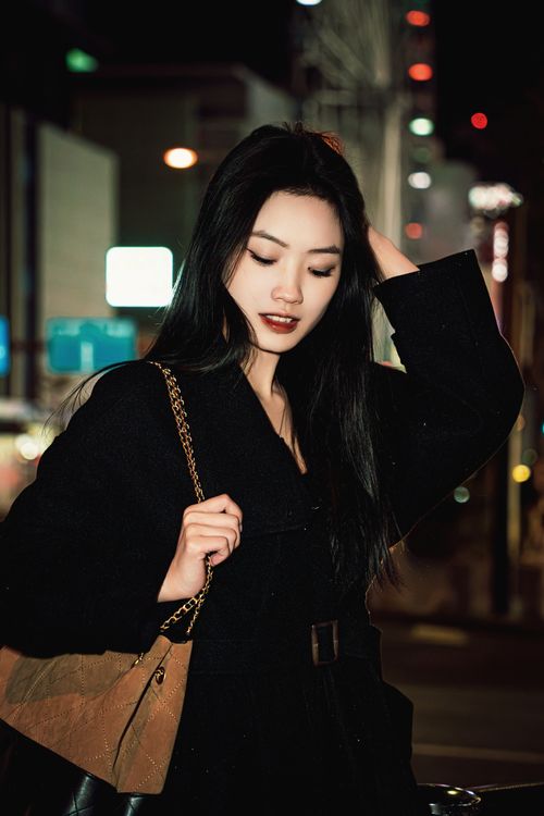 Elegant woman at night in urban setting