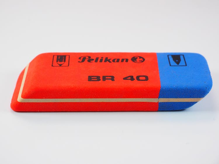 Red And Blue Pelikan Br 40 Eraser On White Surface