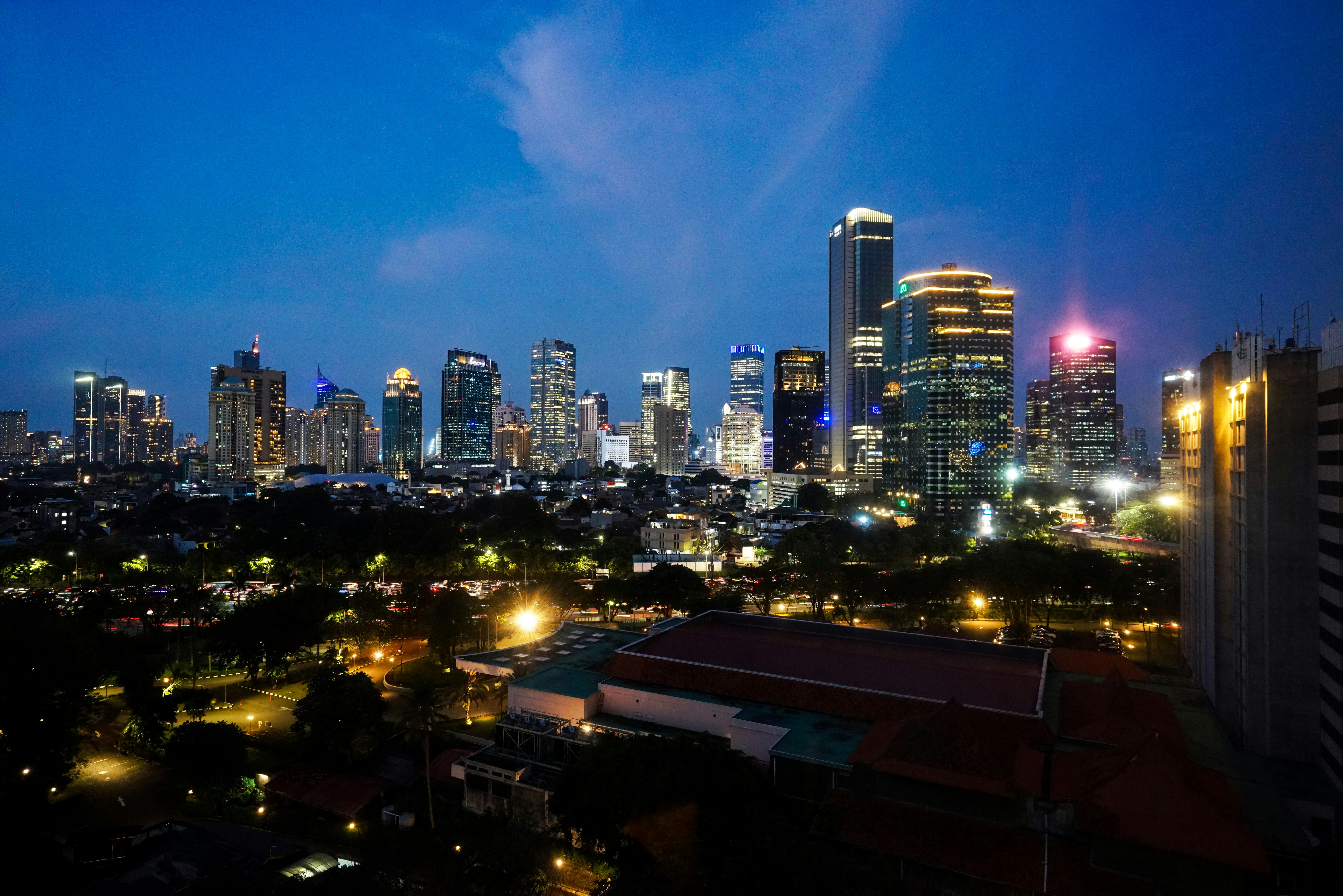 Dazzling night view of Jakarta's illuminated skyline showcasing modern skyscrapers and vibrant lights.
